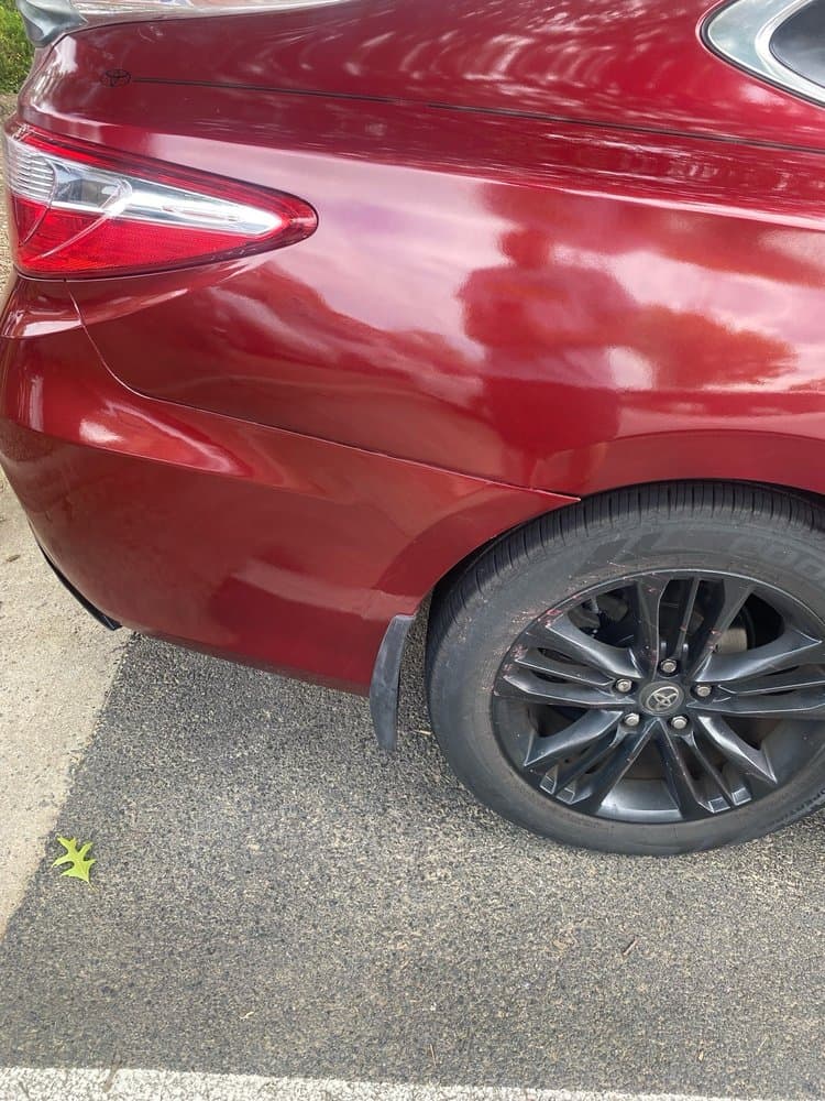 Expert paintless dent repair technician at work